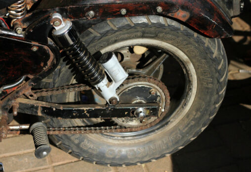 an old motorcycle tyre that is rusting