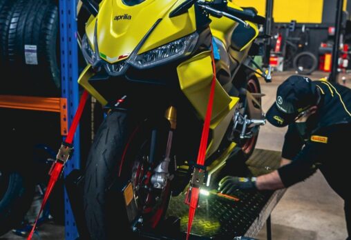 A motorcycle technician inspecting a motorcycle