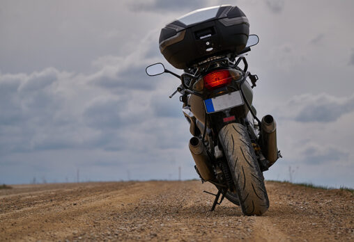 the back of an adventure motorcycle sitting on the road