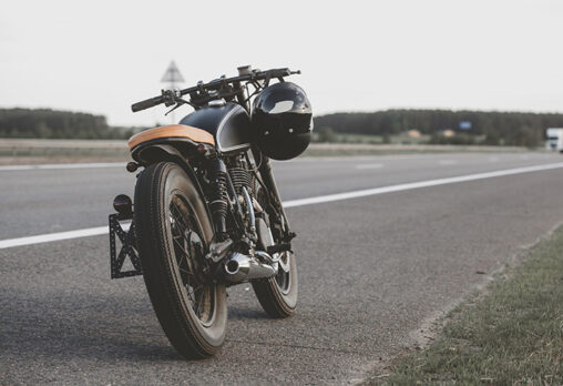 a cafe racer motorcycle sitting on the road