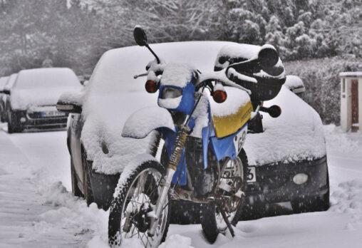 A parked motorcycle in the snow