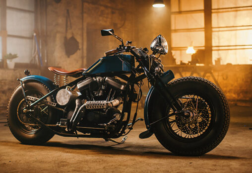 a retro motorcycle sitting in a warehouse