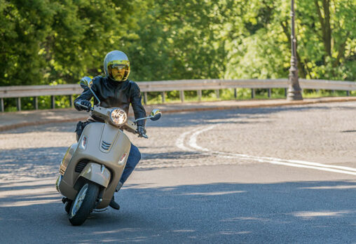 a man riding a scooter on the road