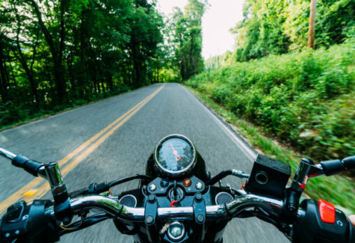 a motorcycle driving fast down a road