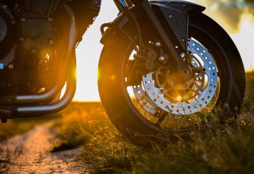 Close up motorbike tyre with the sunset in the background